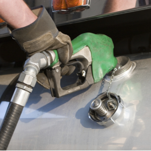 Trucker pumping gas and using ExpressIFTA for IFTA fuel tax reporting
